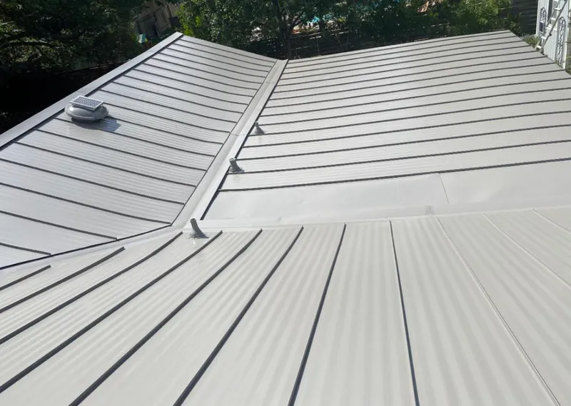 Solar attic fan installed on a metal roof for Roof Ventilation in West Athens